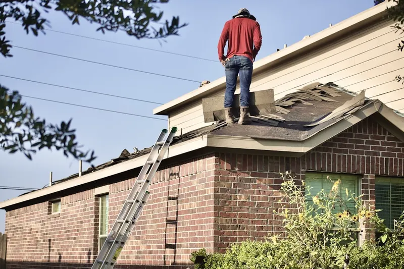 Professional roofer working on a residential roof in Sharon Heights
